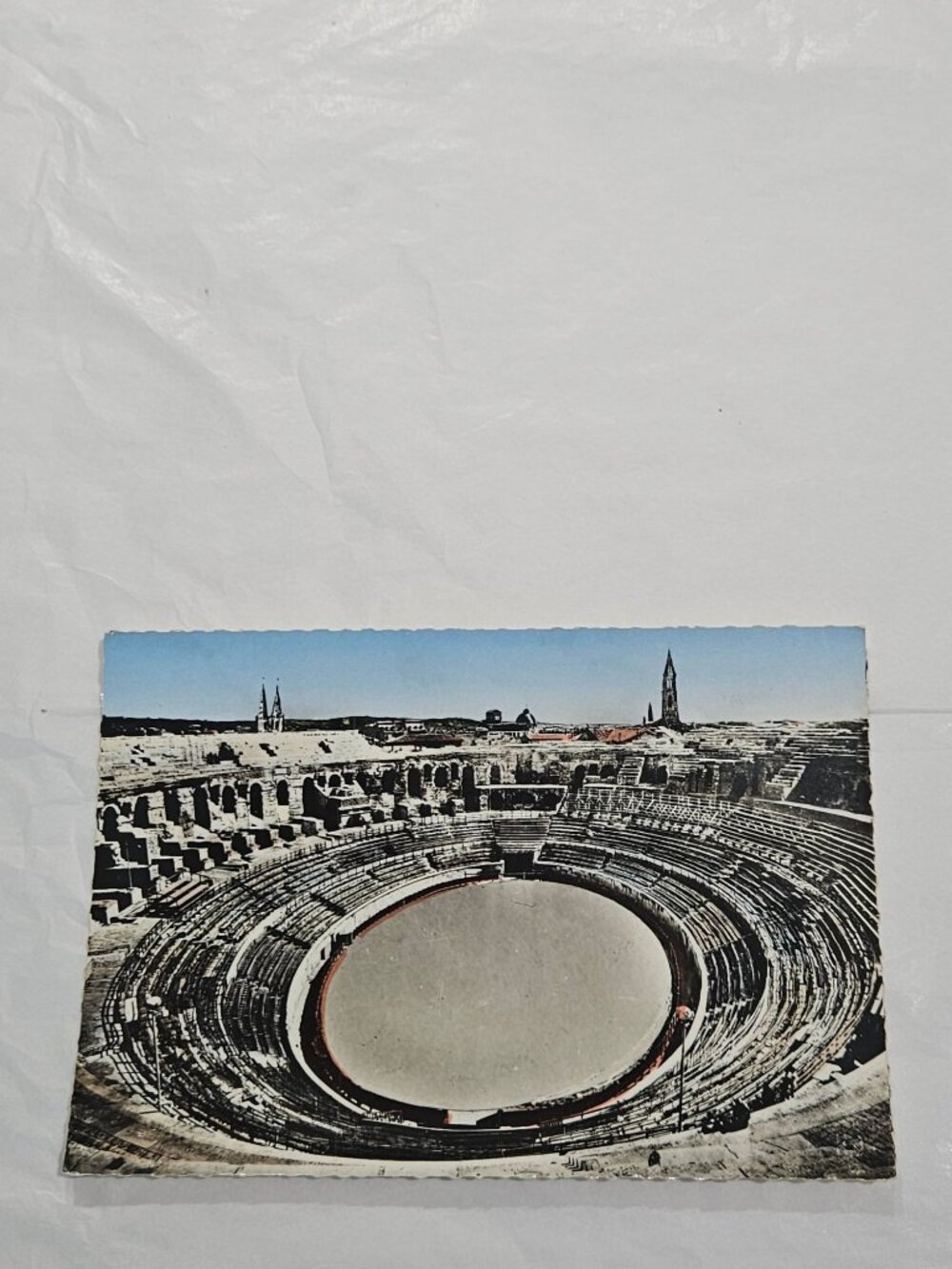 An interior view of the Arènes de Nîmes in France.Postcard
